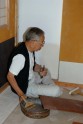 Paperer Tago Yūji at work on the tea house walls. &copy; Ashmolean Museum, University of Oxford