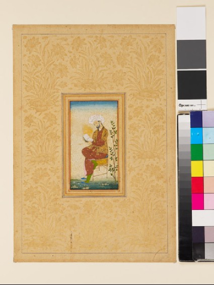 Man seated on a chair reading a bookfront