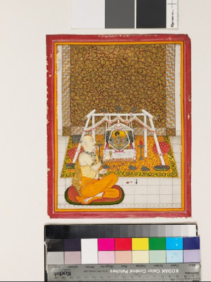 Priest at a Krishna shrinefront