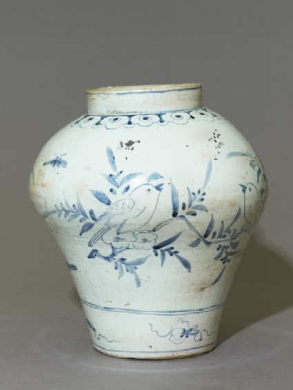 Jar with a bird on a prunus sprayside