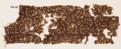 Textile fragment with swirling leavesfront