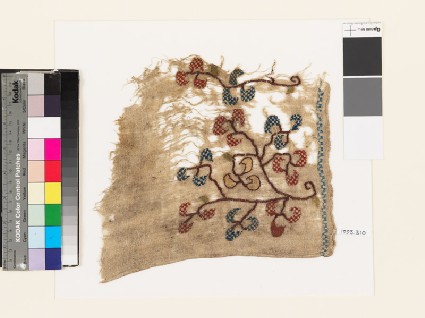 Textile fragment with stylized floral spray and chevronsfront