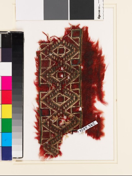 Textile fragment with band of linked diamond-shapes and squaresfront