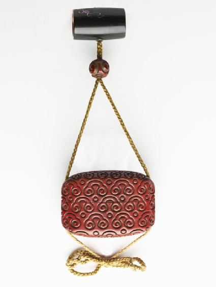 Inrō with scroll design, attached to a netsuke and an ojimefront