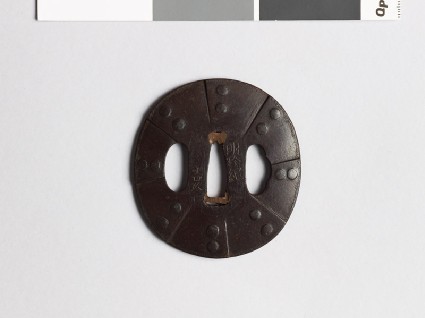 Lenticular tsuba imitating the design of a helmetfront