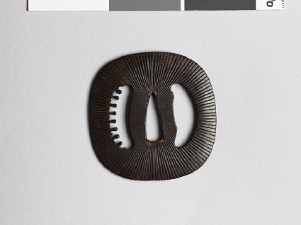 Lenticular tsuba with Amida-yasurime, or radial striationsfront