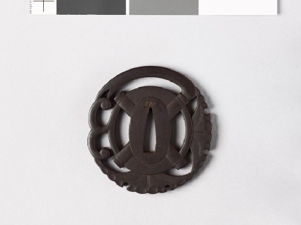 Tsuba in the form of a mamori monfront
