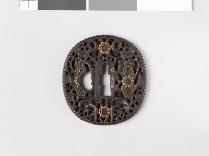 Tsuba with dragons amid scrollworkfront