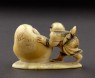 Netsuke in the form of a boy rolling a yuki daruma, or snowman (back)