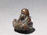 Netsuke in the form of Daruma meditating (side)